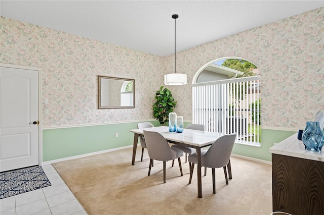 10250 Locker Dr, Spring Hill, FL 34608 - tiled dining space featuring wallpapered walls, baseboards, and carpet flooring