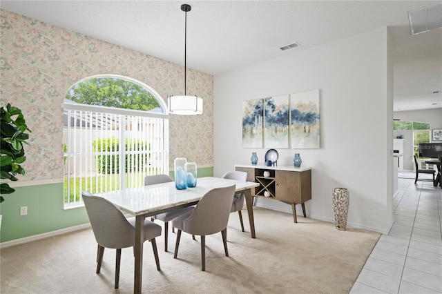 10250 Locker Dr, Spring Hill, FL 34608 - dining space featuring wallpapered walls, baseboards, and light tile patterned flooring