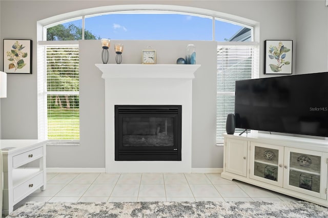 10250 Locker Dr, Spring Hill, FL 34608 - living area with baseboards, light tile patterned floors, and a glass covered fireplace