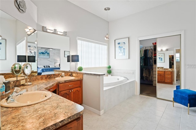 10250 Locker Dr, Spring Hill, FL 34608 - full bath with double vanity, a garden tub, tile patterned floors, ensuite bathroom, and a walk in closet