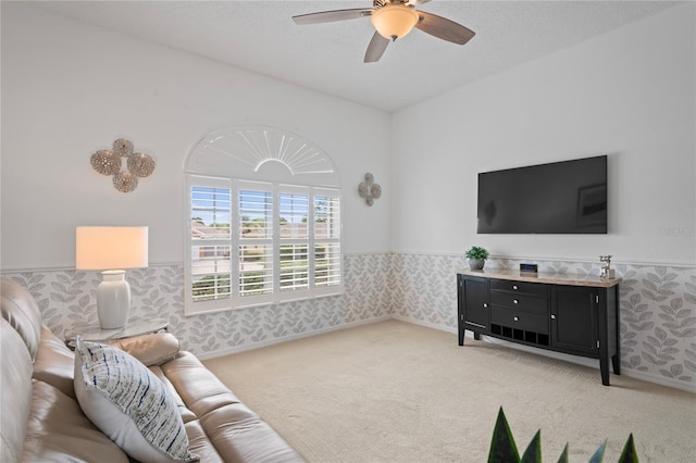 10250 Locker Dr, Spring Hill, FL 34608 - living area featuring a wainscoted wall, light carpet, a ceiling fan, and wallpapered walls