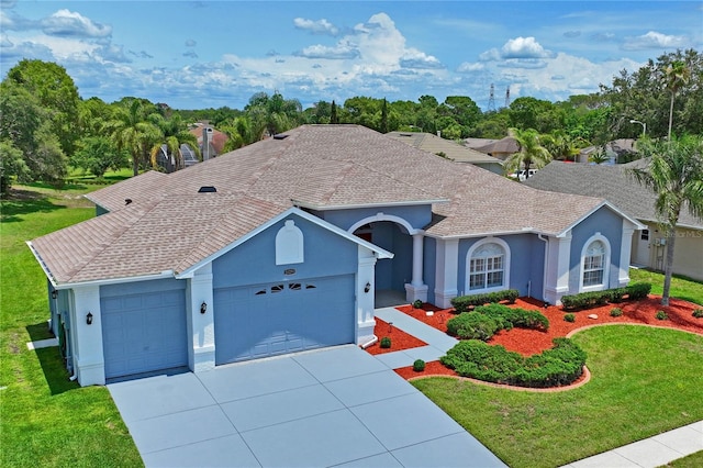 10250 Locker Dr, Spring Hill, FL 34608 - ranch-style home with an attached garage, concrete driveway, a front yard, stucco siding, and roof with shingles