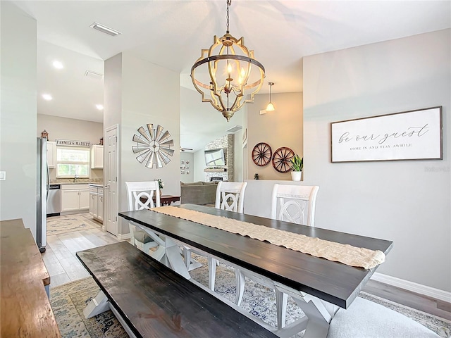 12396 SW 64th Street Rd, Ocala, FL 34481 - dining space featuring a chandelier and light wood-type flooring