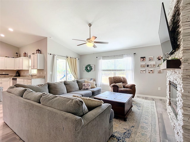 12396 SW 64th Street Rd, Ocala, FL 34481 - living area featuring lofted ceiling, ceiling fan, light wood-style flooring, a fireplace, and plenty of natural light