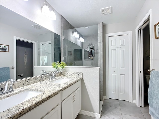 12396 SW 64th Street Rd, Ocala, FL 34481 - full bathroom with double vanity, a walk in shower, a closet, and tile patterned flooring