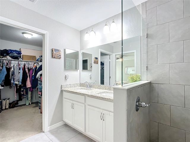 12396 SW 64th Street Rd, Ocala, FL 34481 - bathroom with double vanity, a ceiling fan, a walk in closet, and tiled shower