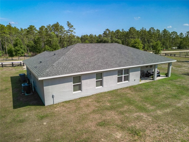 12396 SW 64th Street Rd, Ocala, FL 34481 - rear view of house with roof with shingles, stucco siding, and a patio area
