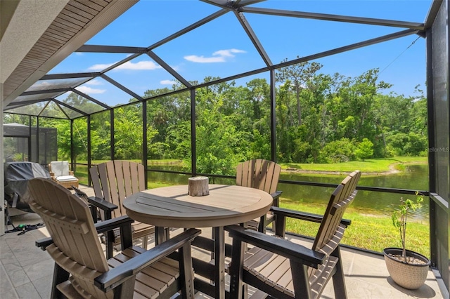 11579 Weaver Hollow Rd, New Port Richey, FL 34654 - view of patio / terrace with outdoor dining area, a water view, and a lanai