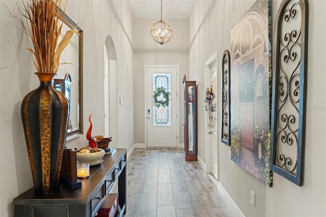 11579 Weaver Hollow Rd, New Port Richey, FL 34654 - foyer entrance featuring a chandelier, arched walkways, and baseboards