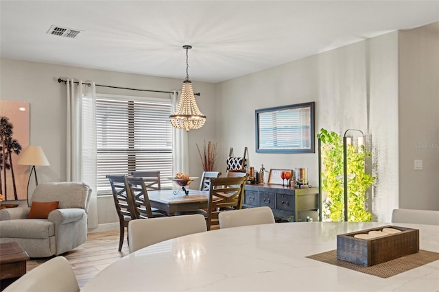 11579 Weaver Hollow Rd, New Port Richey, FL 34654 - dining area with a chandelier and wood finished floors