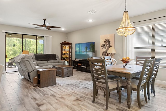 11579 Weaver Hollow Rd, New Port Richey, FL 34654 - dining space featuring a ceiling fan, a chandelier, light wood-style flooring, and recessed lighting
