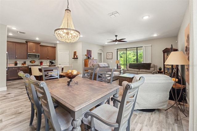11579 Weaver Hollow Rd, New Port Richey, FL 34654 - dining room with light wood finished floors, recessed lighting, ceiling fan, and a chandelier