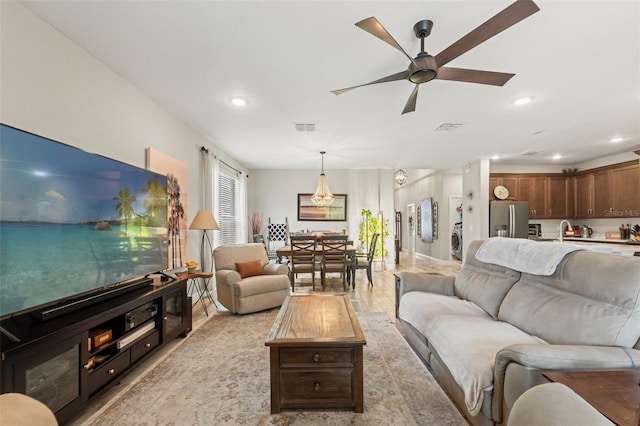11579 Weaver Hollow Rd, New Port Richey, FL 34654 - living room with a ceiling fan, recessed lighting, light wood finished floors, and washer / clothes dryer