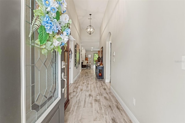 11579 Weaver Hollow Rd, New Port Richey, FL 34654 - foyer with arched walkways, baseboards, and light wood-style flooring