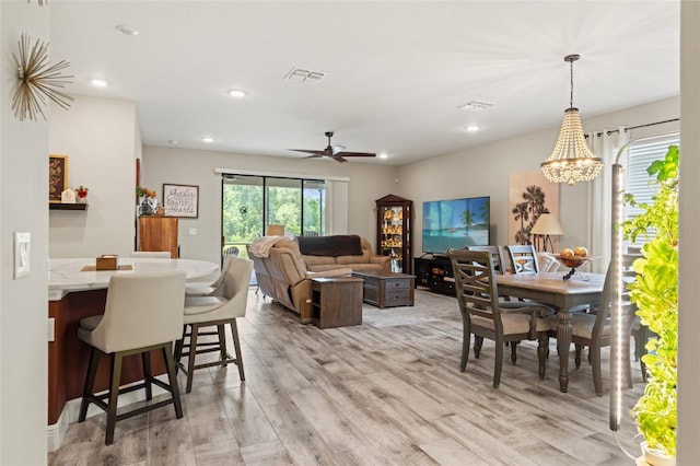 11579 Weaver Hollow Rd, New Port Richey, FL 34654 - dining room featuring light wood-type flooring, a chandelier, recessed lighting, and a ceiling fan