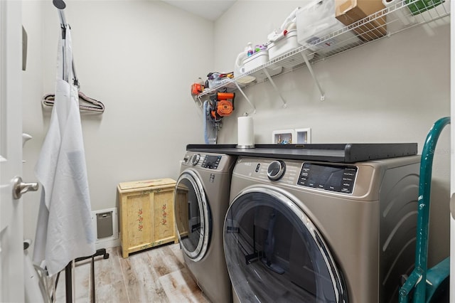 11579 Weaver Hollow Rd, New Port Richey, FL 34654 - laundry room with washing machine and dryer and wood finished floors