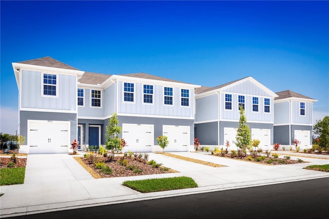 2307 Incandescent Way S, Daytona, FL 32119 - townhome / multi-family property with an attached garage, board and batten siding, and driveway
