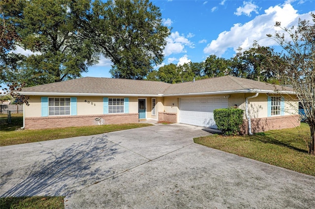4851 NE 7th St, Ocala, FL 34470 - single story home featuring brick siding, a garage, concrete driveway, and stucco siding
