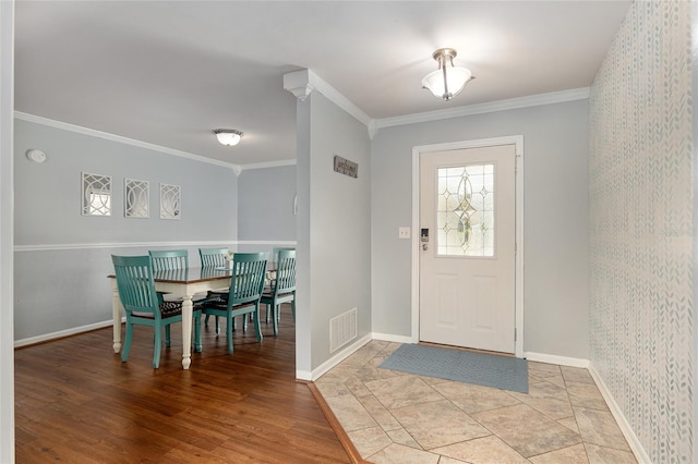4851 NE 7th St, Ocala, FL 34470 - foyer entrance with ornamental molding, baseboards, and light wood-style flooring