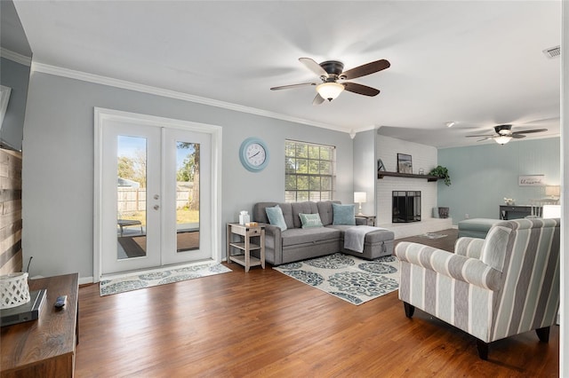 4851 NE 7th St, Ocala, FL 34470 - living area featuring ceiling fan, a brick fireplace, wood finished floors, french doors, and crown molding