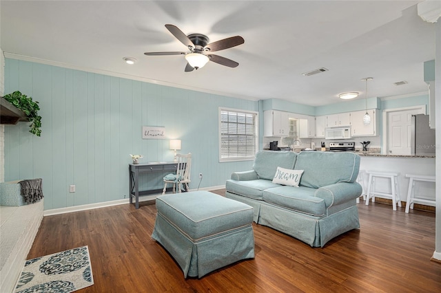 4851 NE 7th St, Ocala, FL 34470 - living area featuring ceiling fan, dark wood-style floors, ornamental molding, and baseboards