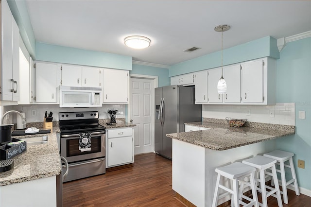 4851 NE 7th St, Ocala, FL 34470 - kitchen featuring appliances with stainless steel finishes, a sink, backsplash, ornamental molding, and light stone counters