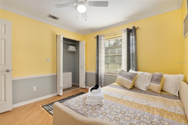 4851 NE 7th St, Ocala, FL 34470 - bedroom with wood finished floors, ornamental molding, baseboards, a closet, and ceiling fan