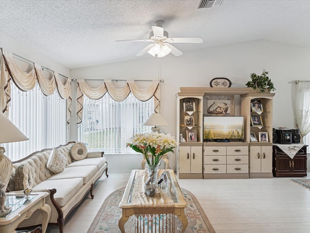 3832 Sailmaker Ln Unit 3832, Holiday, FL 34691 - living area featuring lofted ceiling, a ceiling fan, light wood finished floors, and a textured ceiling