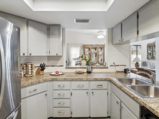 3832 Sailmaker Ln Unit 3832, Holiday, FL 34691 - kitchen with freestanding refrigerator, a sink, dishwashing machine, tasteful backsplash, and light countertops