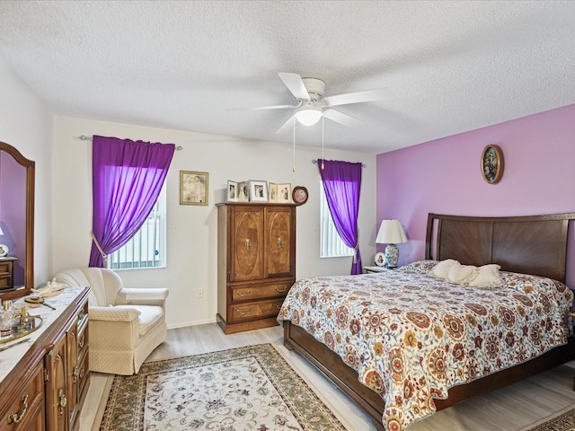 3832 Sailmaker Ln Unit 3832, Holiday, FL 34691 - bedroom featuring a textured ceiling, light wood-style flooring, and ceiling fan