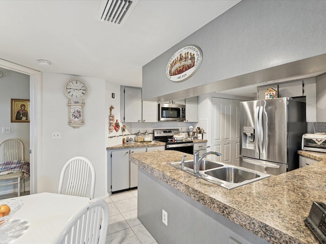 3832 Sailmaker Ln Unit 3832, Holiday, FL 34691 - kitchen with stainless steel appliances, a sink, tasteful backsplash, and light countertops