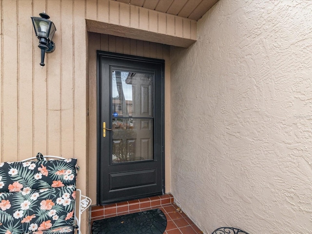 3832 Sailmaker Ln Unit 3832, Holiday, FL 34691 - doorway to property featuring stucco siding