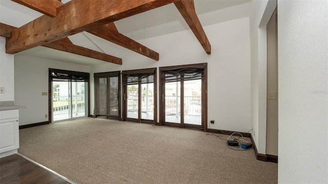 6322 Aureau Ave, Hudson, FL 34667 - unfurnished living room with dark carpet and baseboards