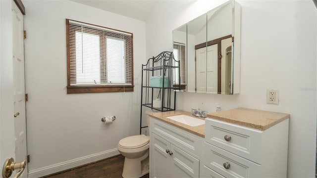 6322 Aureau Ave, Hudson, FL 34667 - bathroom featuring vanity, toilet, baseboards, and wood finished floors