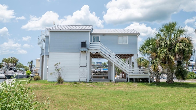 6322 Aureau Ave, Hudson, FL 34667 - rear view of property with stairway, a yard, and metal roof
