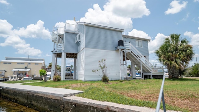 6322 Aureau Ave, Hudson, FL 34667 - rear view of property featuring stairway, a yard, and a balcony
