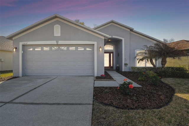 11637 Spindrift Loop, Hudson, FL 34667 - single story home with stucco siding, driveway, and an attached garage