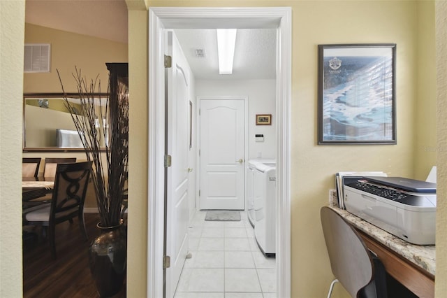 11637 Spindrift Loop, Hudson, FL 34667 - laundry area with washer and clothes dryer and light tile patterned flooring