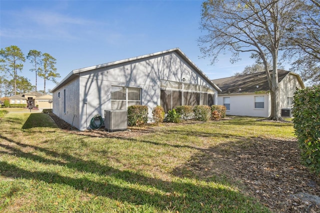 11637 Spindrift Loop, Hudson, FL 34667 - rear view of house featuring a lawn