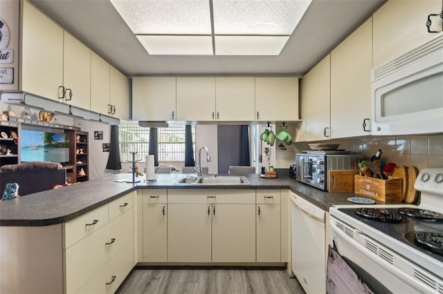 4350 Sawgrass Blvd, New Port Richey, FL 34653 - kitchen featuring white appliances, cream cabinets, and a sink