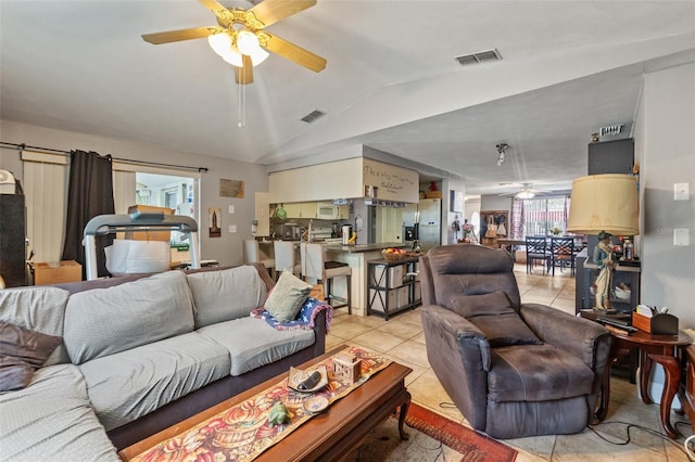 4350 Sawgrass Blvd, New Port Richey, FL 34653 - living area featuring a ceiling fan, light tile patterned floors, and vaulted ceiling