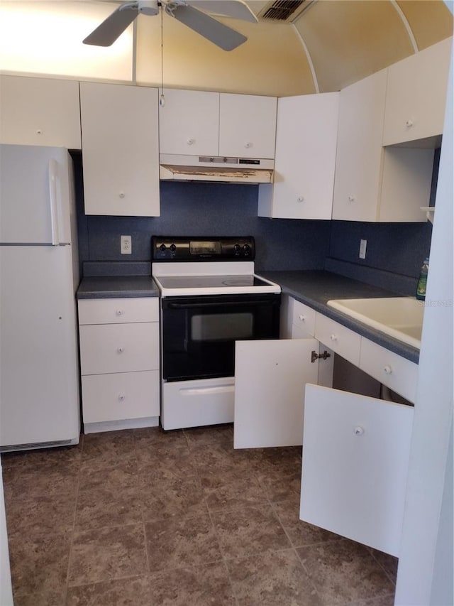 11715 Boynton Ln Unit 74B, New Port Richey, FL 34654 - kitchen with freestanding refrigerator, electric range oven, under cabinet range hood, white cabinetry, and a sink