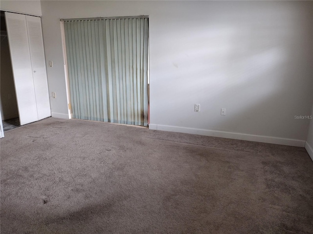 11715 Boynton Ln Unit 74B, New Port Richey, FL 34654 - empty room featuring baseboards and carpet