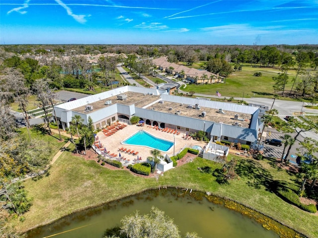 11715 Boynton Ln Unit 74B, New Port Richey, FL 34654 - bird's eye view of a pool, a tree filled landscape, and a nearby body of water