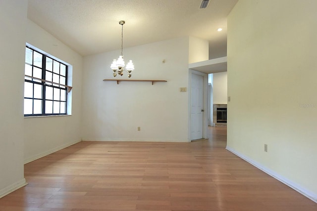 11364 Orangewood Ct, Spring Hill, FL 34609 - spare room featuring a chandelier, light wood-type flooring, and baseboards