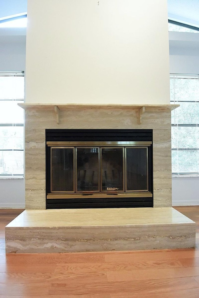 11364 Orangewood Ct, Spring Hill, FL 34609 - detailed view of a glass covered fireplace, wood finished floors, and baseboards
