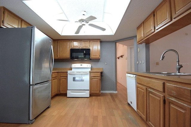 11364 Orangewood Ct, Spring Hill, FL 34609 - kitchen featuring white appliances, a sink, a ceiling fan, light wood finished floors, and light countertops