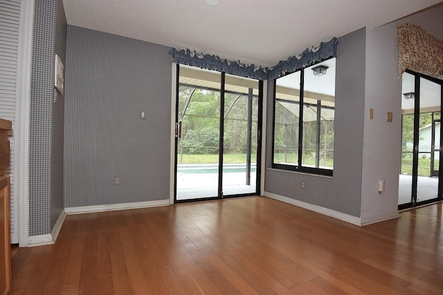 11364 Orangewood Ct, Spring Hill, FL 34609 - unfurnished dining area featuring baseboards, wood-type flooring, and plenty of natural light