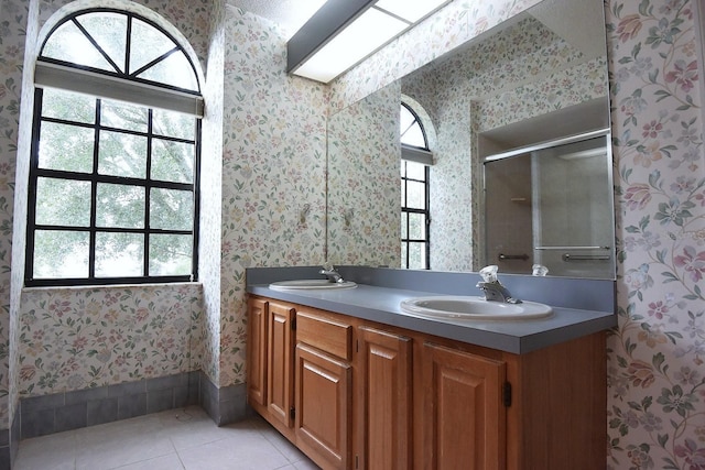 11364 Orangewood Ct, Spring Hill, FL 34609 - full bath with wallpapered walls, tile patterned floors, double vanity, and a shower stall