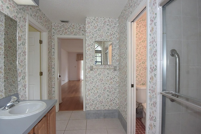 11364 Orangewood Ct, Spring Hill, FL 34609 - bathroom with wallpapered walls, vanity, tile patterned floors, toilet, and a shower stall